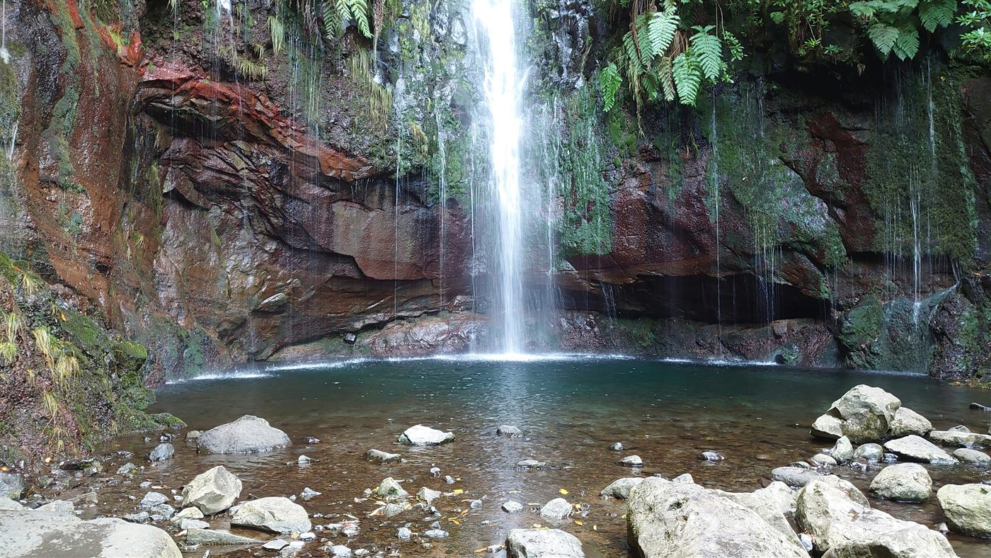 Waterfall surrounded by green vegetation in East Madeira