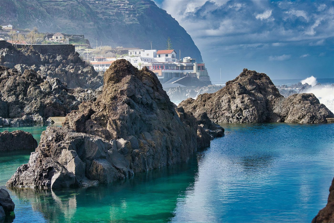 Volcanic rock pools and blue water at Porto Moniz